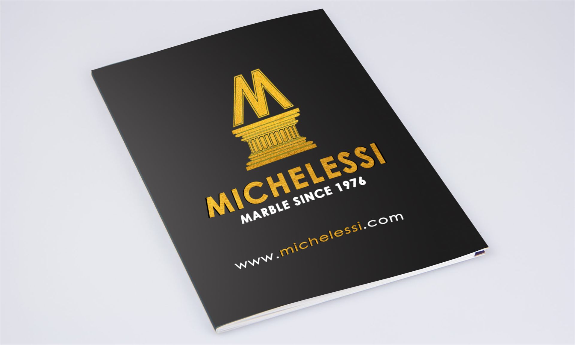 Copertina nera del catalogo Michelessi Marble Since 1976 con logo dorato a forma di colonna