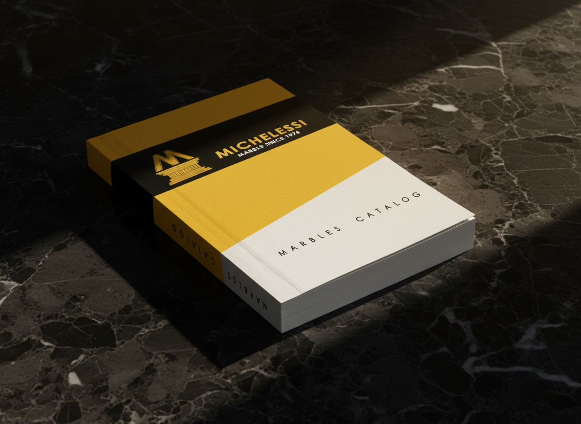 Volume del catalogo marmi Michelessi, copertina gialla e nera con logo e scritta Marble since 1976
