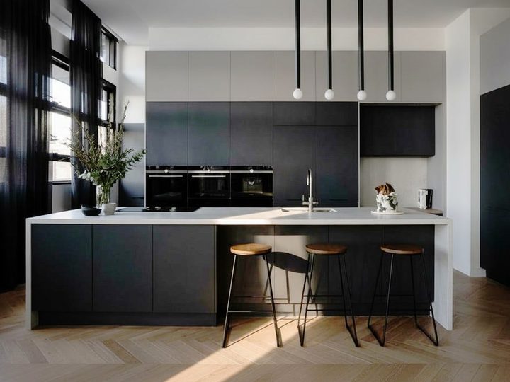 Elegant graphite lacquered wood kitchen with bar top, induction, oven, sink and fridge