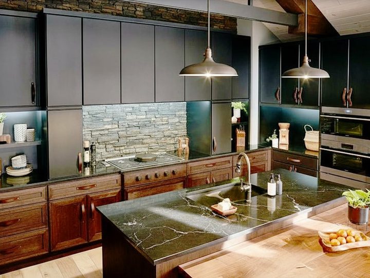 Solid walnut kitchen with polished veined marble worktop and natural stone feature wall