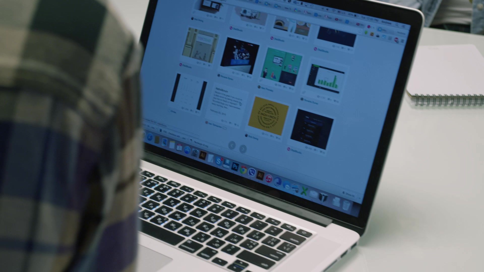 Person at a laptop reviewing a project portfolio on screen, Michelessi Marble work with us careers page