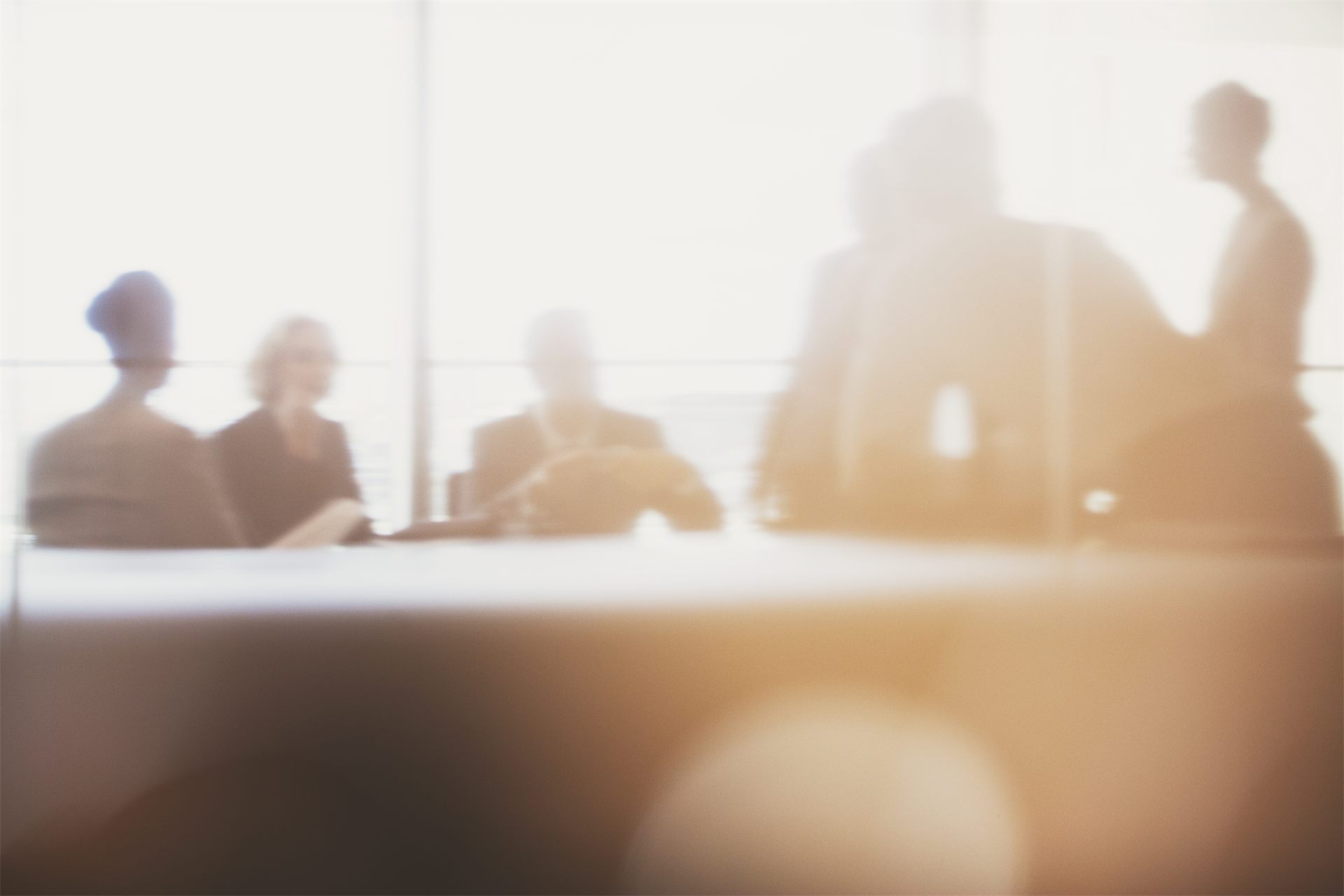 Backlit silhouettes of people in a meeting in a bright room, careers and work with us at Michelessi Marble