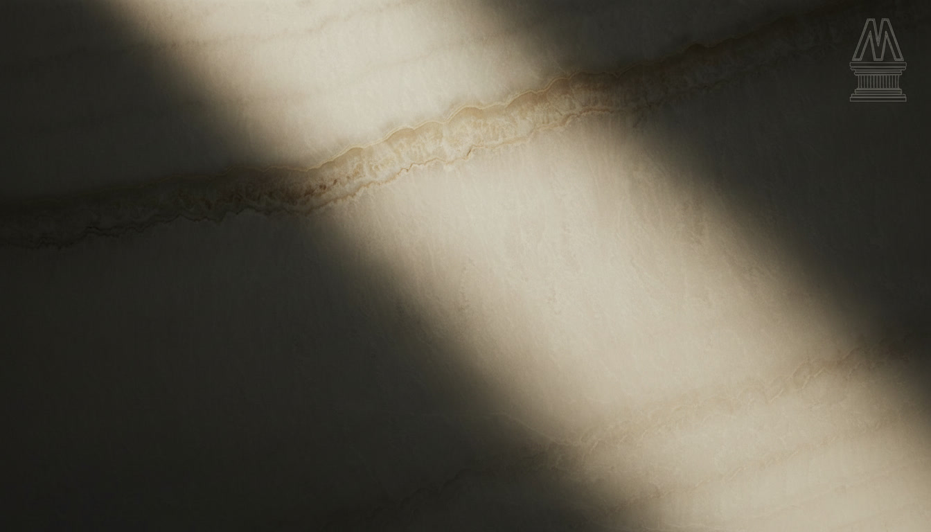 Onice Ivory slab, uniform ivory ground crossed by a sinuous golden band, Michelessi natural stones