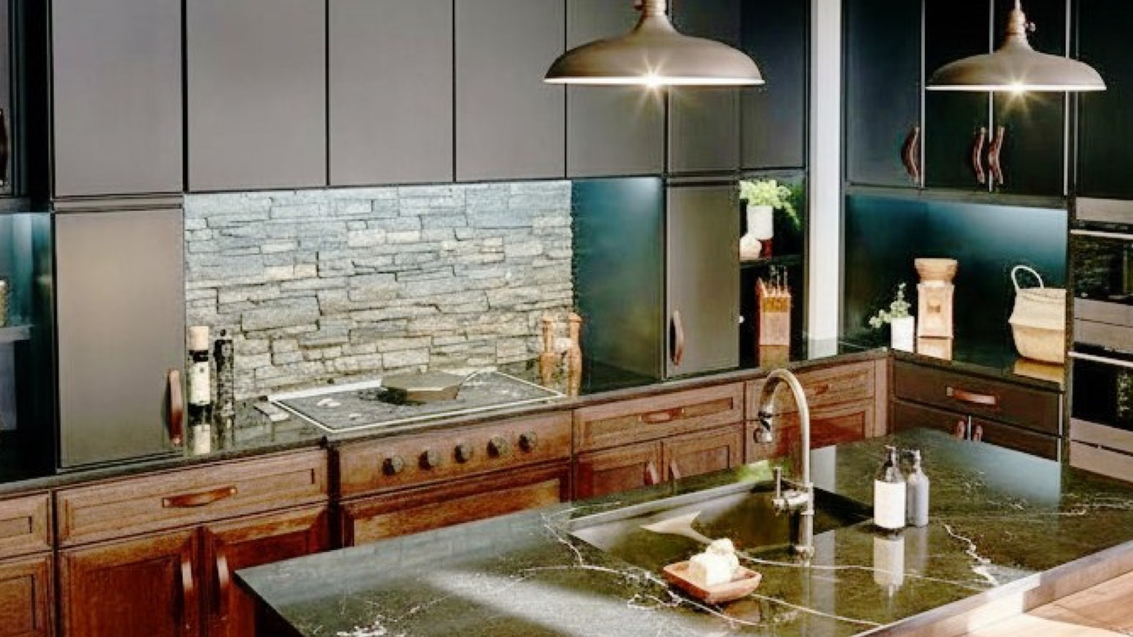 Solid walnut kitchen with polished veined marble worktop and natural stone feature wall