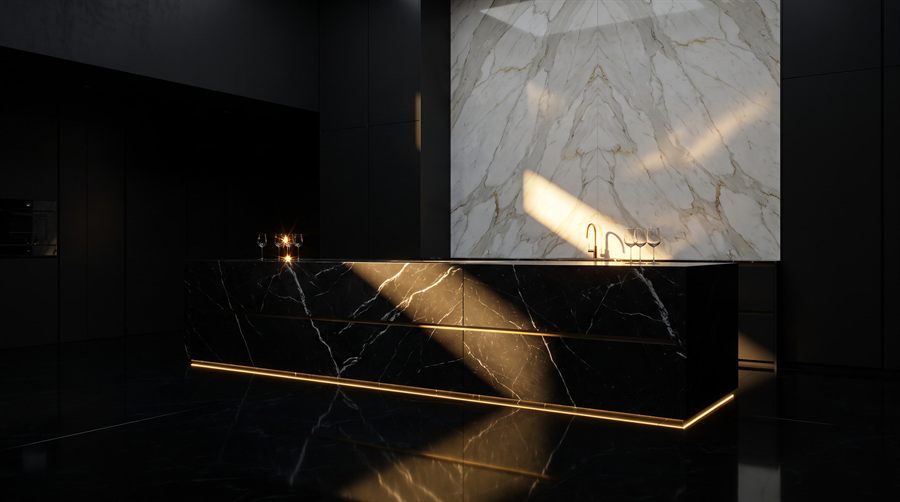 Design vision: monolithic Nero Marquina island before a Calacatta gold wall, preview of the kitchens collection